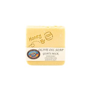 Unscented, honey goats milk olive oil soap bar block. Honey in colour with the word "honey" with a bee flying toward a hive with a dotted trail, in the design and a Lisadurne Hill brand label